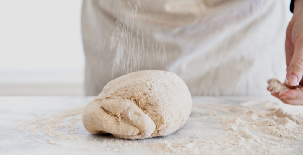 Dough ball with flour sprinkled on top.